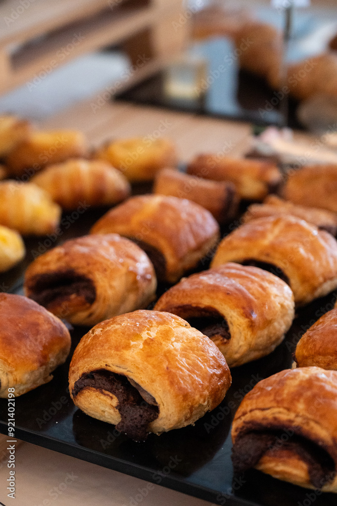 Close-up of freshly baked chocolate croissants on a display tray Close-up of freshly baked chocolate croissants on a display tray
