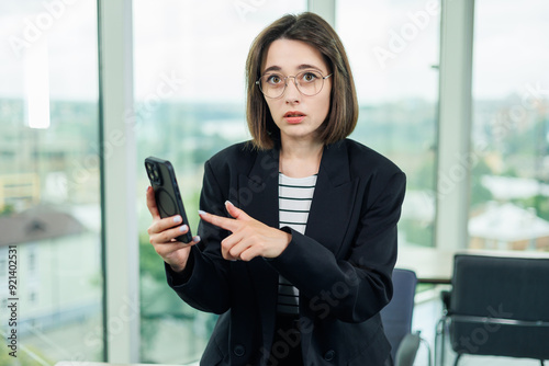 A young woman is working in a spacious office and talking on the phone. Successful people are working on a new business project. Collective work in the office Free Download A young woman is working in a spacious office and talking on the phone. Successful people are working on a new business project. Collective work in the office - GFXLoad