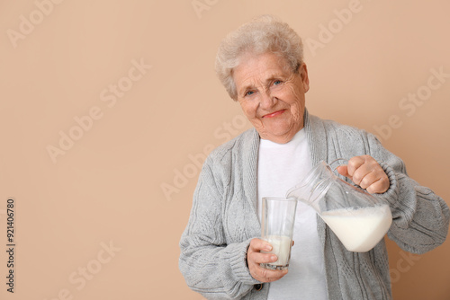 Senior woman pouring milk i...