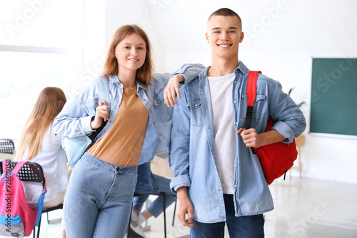 Happy students with backpac...