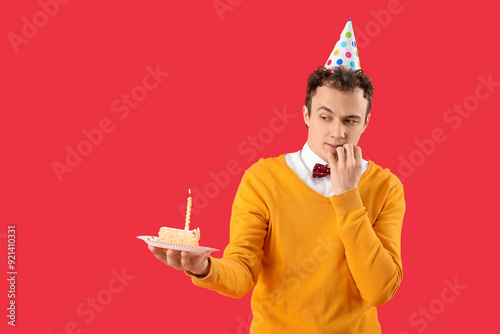 Young man with birthday cak...