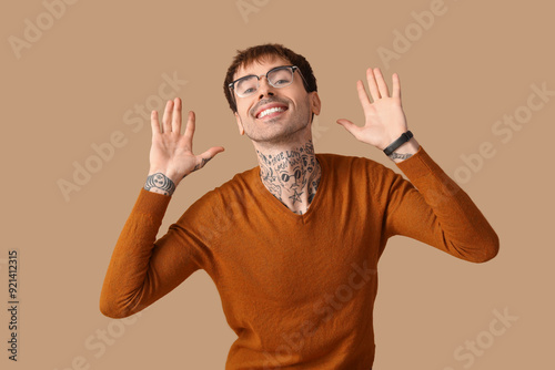 Happy young man on brown background photo