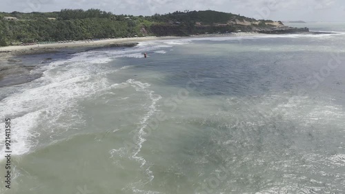 Drone follows from far behind kite surfer photo