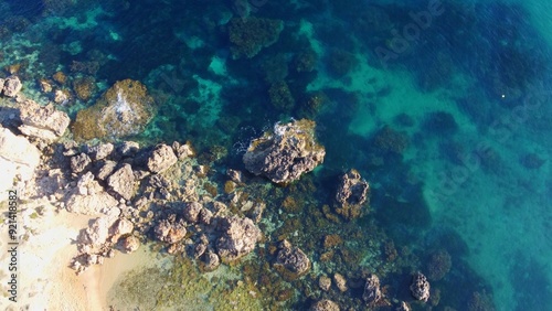 Rocky beach and sapphire sea water on the Maltese island, mediterranean sea, Ghajn Tuffieha bay , Malta. High quality photo