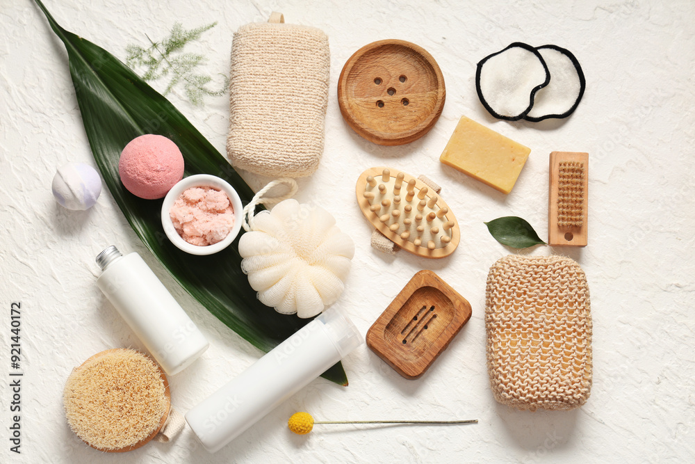 Composition with bath supplies, cosmetic products and plant leaf on light background Composition with bath supplies, cosmetic products and plant leaf on light background