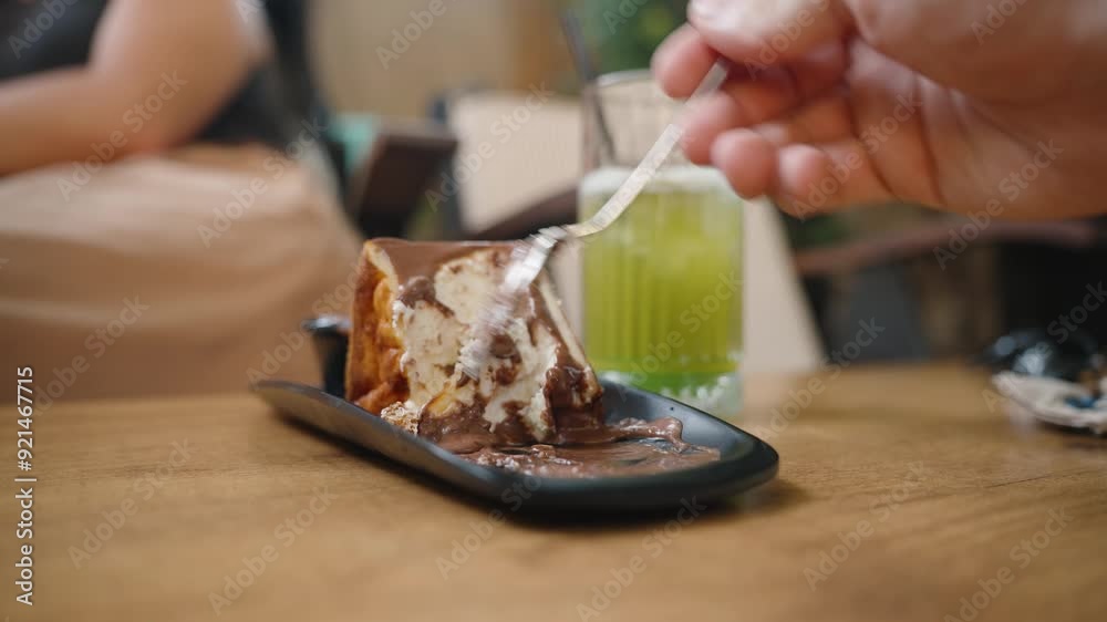 Delicious Dessert, a close-up of a spoonful of cake covered in chocolate. The green juice adds a refreshing contrast. Delicious Dessert, a close-up of a spoonful of cake covered in chocolate. The green juice adds a refreshing contrast.