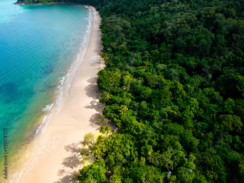 Remote beach in Australia on a sunny day. Daintree and Cape Tribulation location with rainforest and reef taken by drone