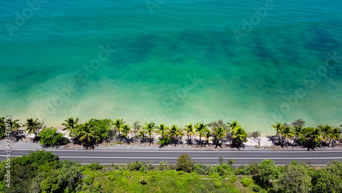 Port Douglas Coast Road, green water, tropical view wtih car driving past on highway photo