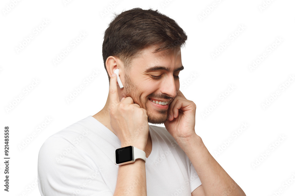 Young man in white t-shirt, wearing smartwatch and listening to music via wireless earphones Young man in white t-shirt, wearing smartwatch and listening to music via wireless earphones