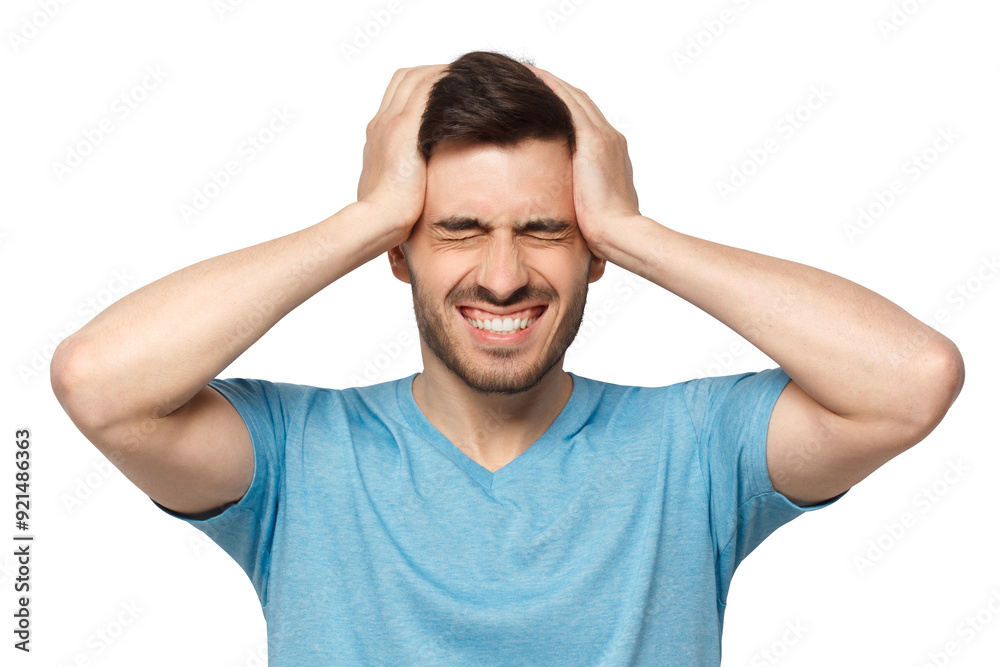 Portrait of young man suffering from severe headache, holding head with both hands, closed eyes with helpless face expression Portrait of young man suffering from severe headache, holding head with both hands, closed eyes with helpless face expression