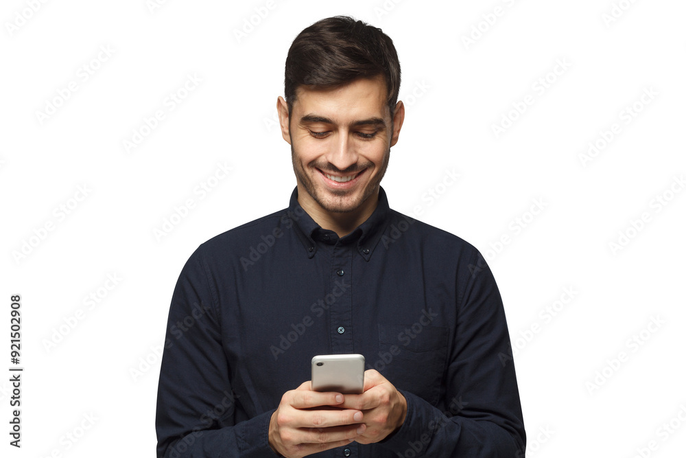 Young smiling businessman in deep blue shirt reading message, using phone Young smiling businessman in deep blue shirt reading message, using phone