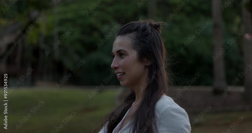 Young mom walks through tropical resort at sunset - side profile Young mom walks through tropical resort at sunset - side profile