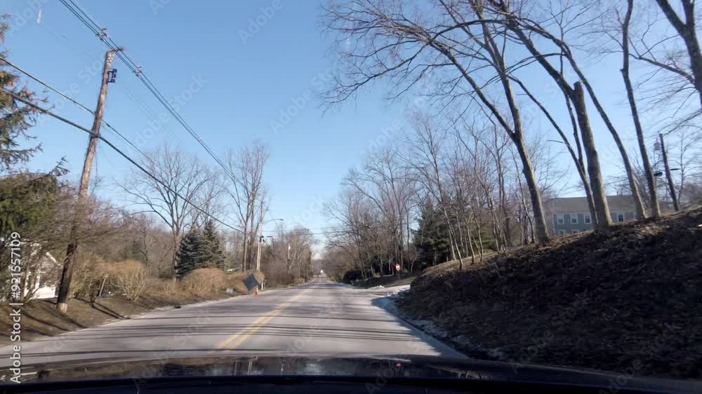 driving county road in suburban area in winter with snow on the ground driving county road in suburban area in winter with snow on the ground