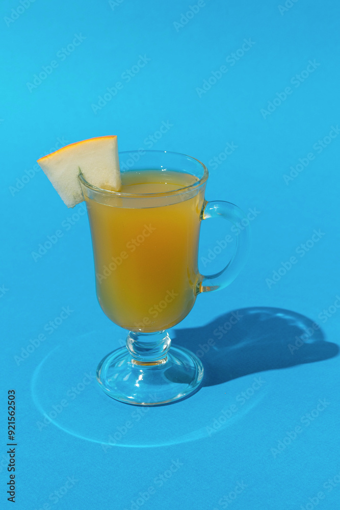 Refreshing Summer Drink with Lime Slice in a Clear Glass on Bright Blue Background Refreshing Summer Drink with Lime Slice in a Clear Glass on Bright Blue Background