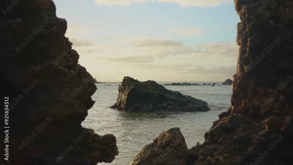 Dramatic coastal cliffs at golden hour peaceful seascape with backlit rocks