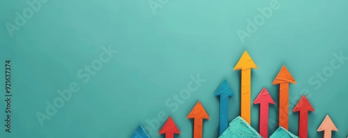 Colorful arrows pointing upwards symbolize growth and progress on a vibrant turquoise background. Ideal for business concepts. photo