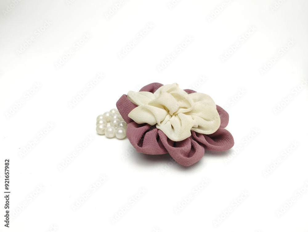 Burgundy and white brooch and handmade beads resemble bright flowers isolated on white background Burgundy and white brooch and handmade beads resemble bright flowers isolated on white background