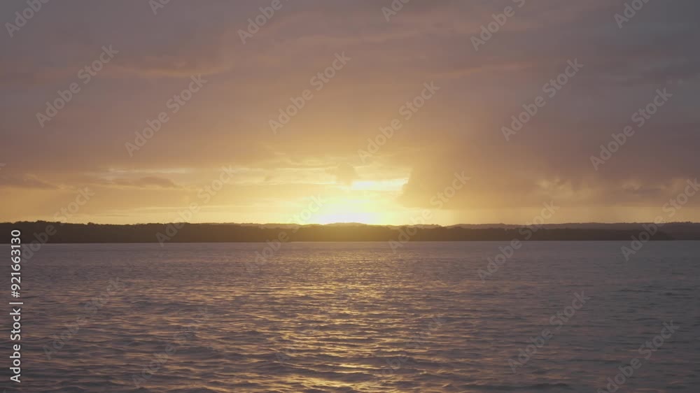 A breathtaking sunset from a boat, capturing the last rays of the orange sun with scattered clouds, and slow-motion ripples on the water, creating a serene and tranquil scene. A breathtaking sunset from a boat, capturing the last rays of the orange sun with scattered clouds, and slow-motion ripples on the water, creating a serene and tranquil scene.