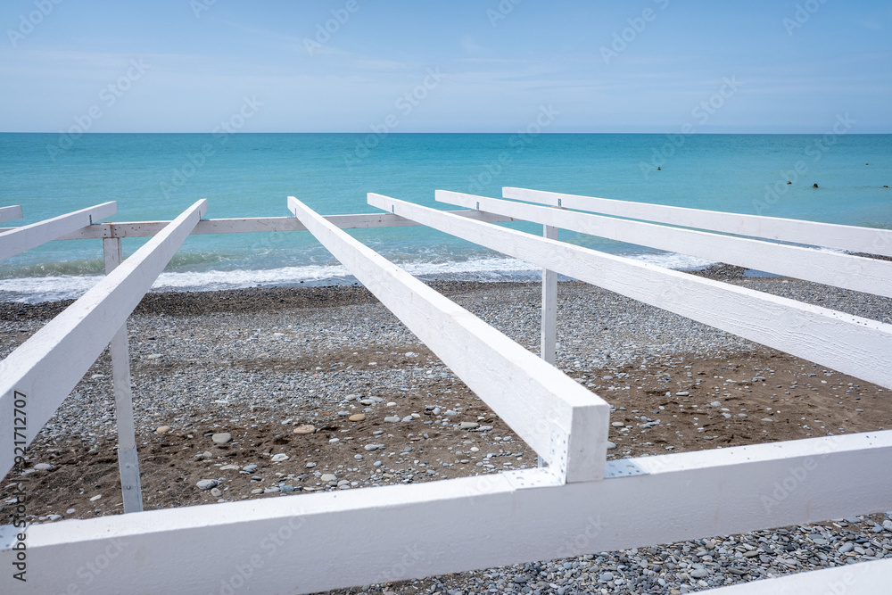White wooden roof slats against the sky. White wooden roof slats against the sky.