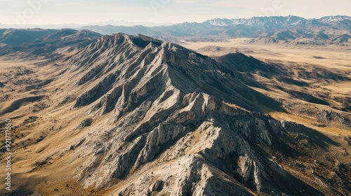 Aerial shot of a rocky mountain range with a clear sky, ideal for placing a message