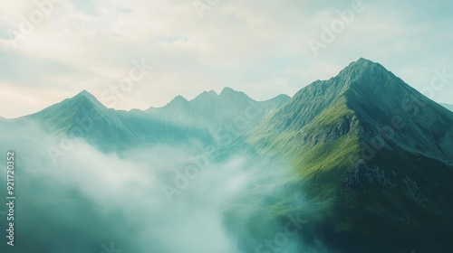 High-angle shot of a mountain range with morning mist, leaving room for a message in the sky