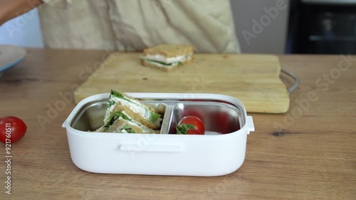 Woman preparing lunch box at kitchen