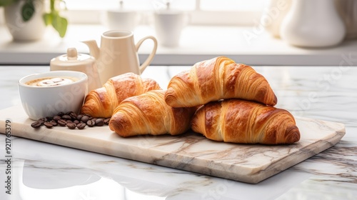 Freshly baked croissants on a marble countertop with a cup of coffee