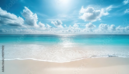 Sunlit beach with azure waters and fluffy clouds during midday