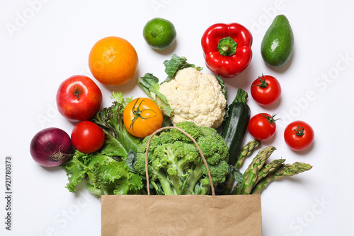 Fototapeta Naklejka Na Ścianę i Meble -  Delivery of vegetarian products. Bag with different vegetables and fruits on white background, top view