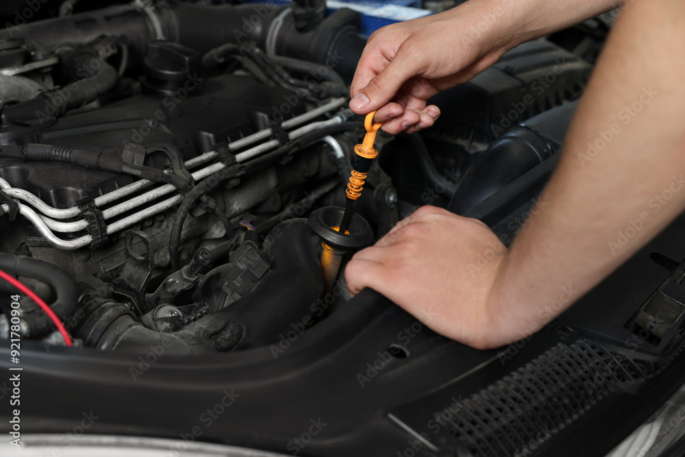 Auto mechanic fixing car at automobile repair shop, closeup Auto mechanic fixing car at automobile repair shop, closeup