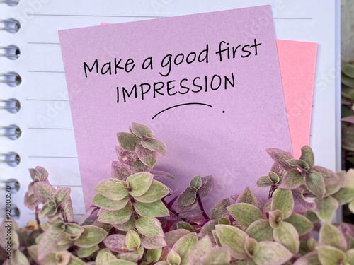 Make a good first impression text written on paper with flower background. Stock photo.