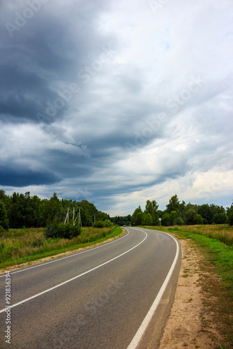 Menacing rain clouds moving towards the highway, landscape before the downpour