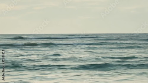 Wallpaper Mural The ocean is calm and the sky is cloudy. The water is blue and the waves are small Torontodigital.ca