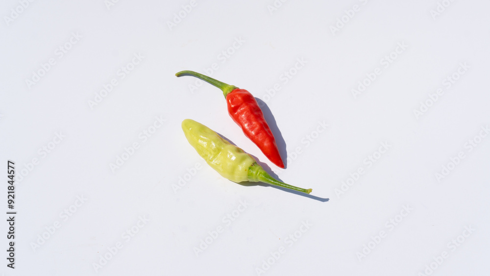 Bright Red and Green Chilies on a White Surface Bright Red and Green Chilies on a White Surface