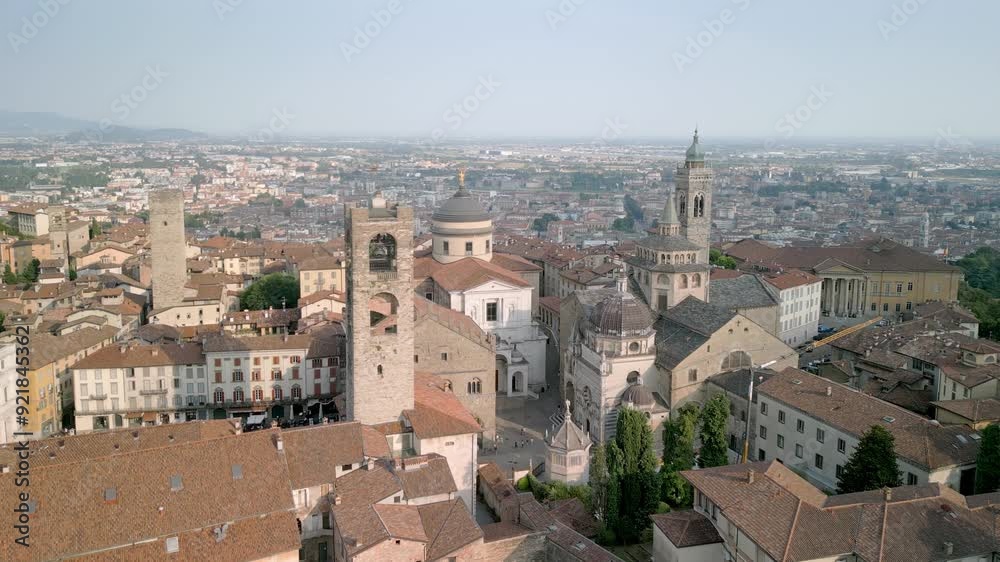 Drone flight over Bergamo Alta, Città Alta. You can see the Duomo, the Colleoni Chapel, Palazzo della Ragione, the Campanone, the Gombito tower and below the new city of Bergamo Bassa Drone flight over Bergamo Alta, Città Alta. You can see the Duomo, the Colleoni Chapel, Palazzo della Ragione, the Campanone, the Gombito tower and below the new city of Bergamo Bassa