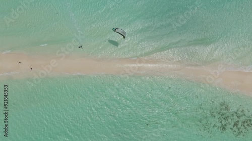Top down shot of a kitesurfer jumping the Cayo Agua land bridge in Los Roques, Venezuela.