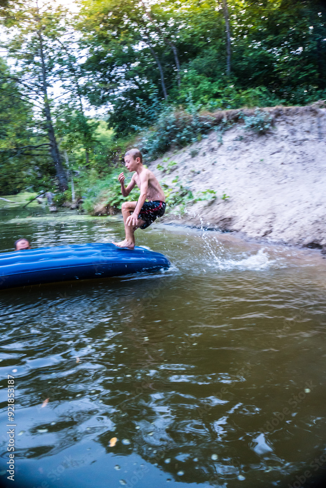 a boy bathes in a river in the summer on a hot day a boy bathes in a river in the summer on a hot day
