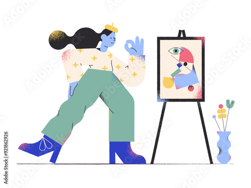 Female artist showing ok sign next to painting