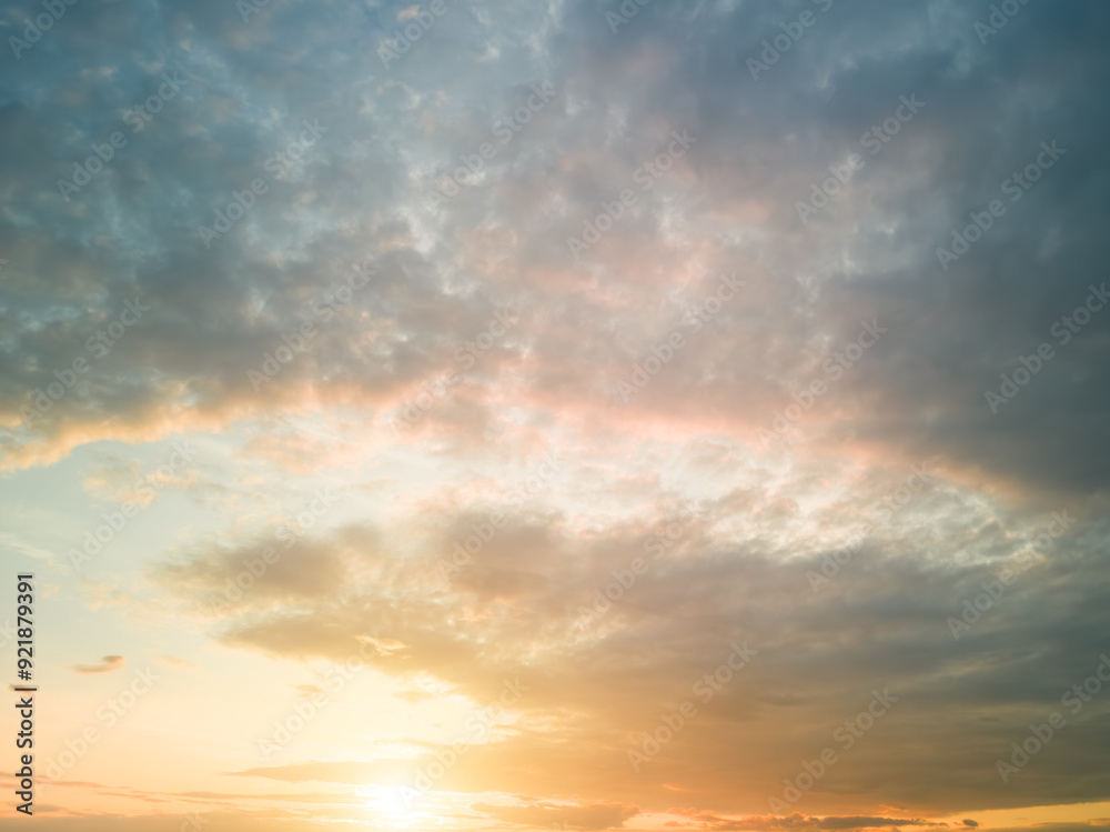 The rays of the sun breaking through the dramatic clouds in the evening or in the morning in the sunset or sunrise sky.