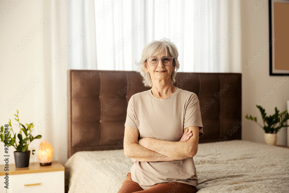 Portrait of senior woman sitting on bed cozy nursing home. Portrait of senior woman sitting on bed cozy nursing home.