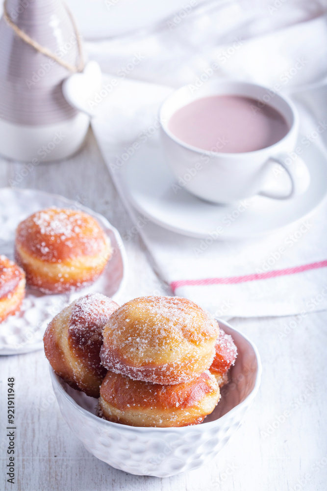 Donuts with sugar and cinnamon served with cocoa. Traditional dessert for Carnival.