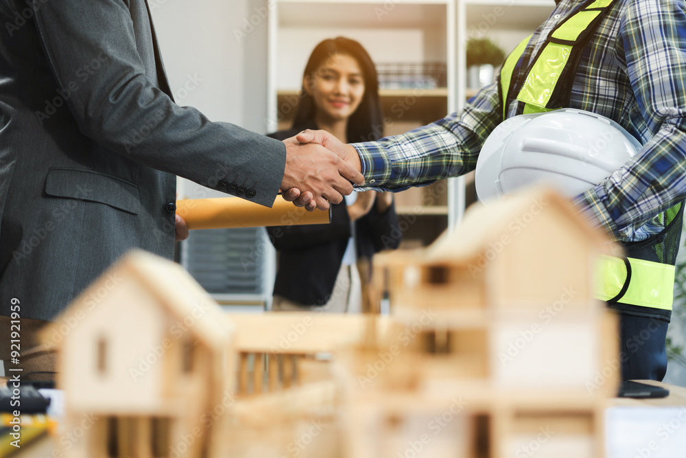 Fototapeta premium Team architects workers, men and women, join hands to join forces to join forces to work for the industry for success. Teamwork and professional colleagues : Workers' hands, teamwork concept.
