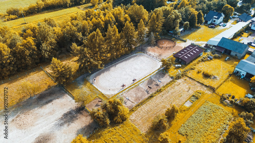 Horseback riders training on spacious equestrian grounds