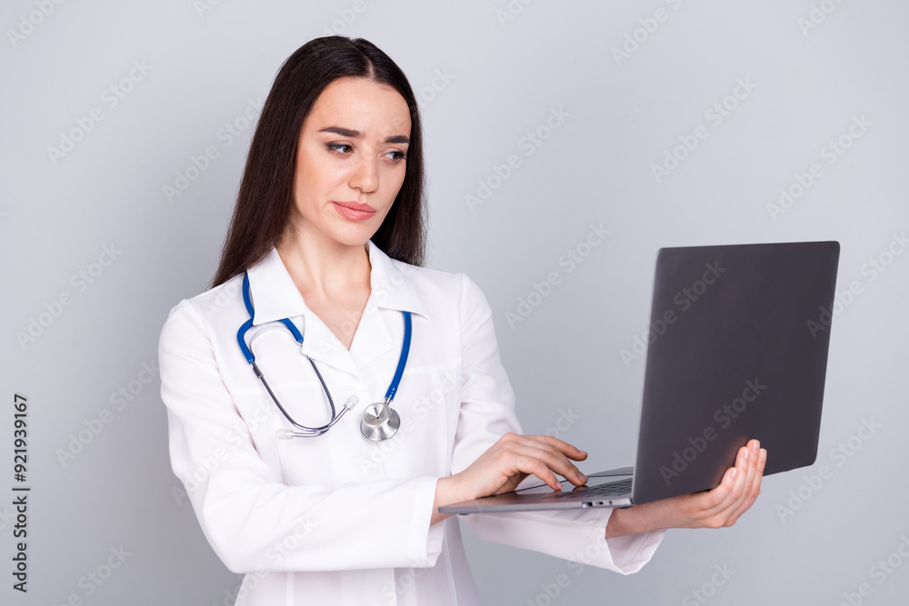 Photo of qualified specialist therapist wear white doctor robe use device isolated on grey color background Photo of qualified specialist therapist wear white doctor robe use device isolated on grey color background