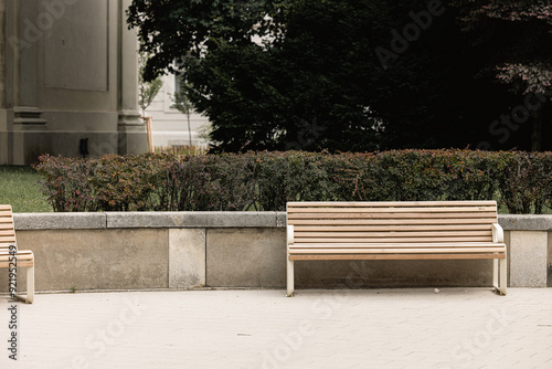 Modern benches in the city square on a sunny day. City improvement, urban planning, public spaces.