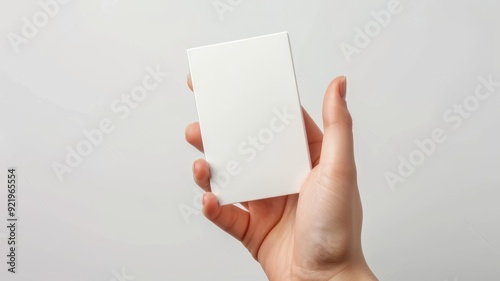 white business card positioned vertically in hand, white background