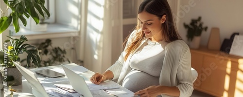 Pregnant woman working at h...