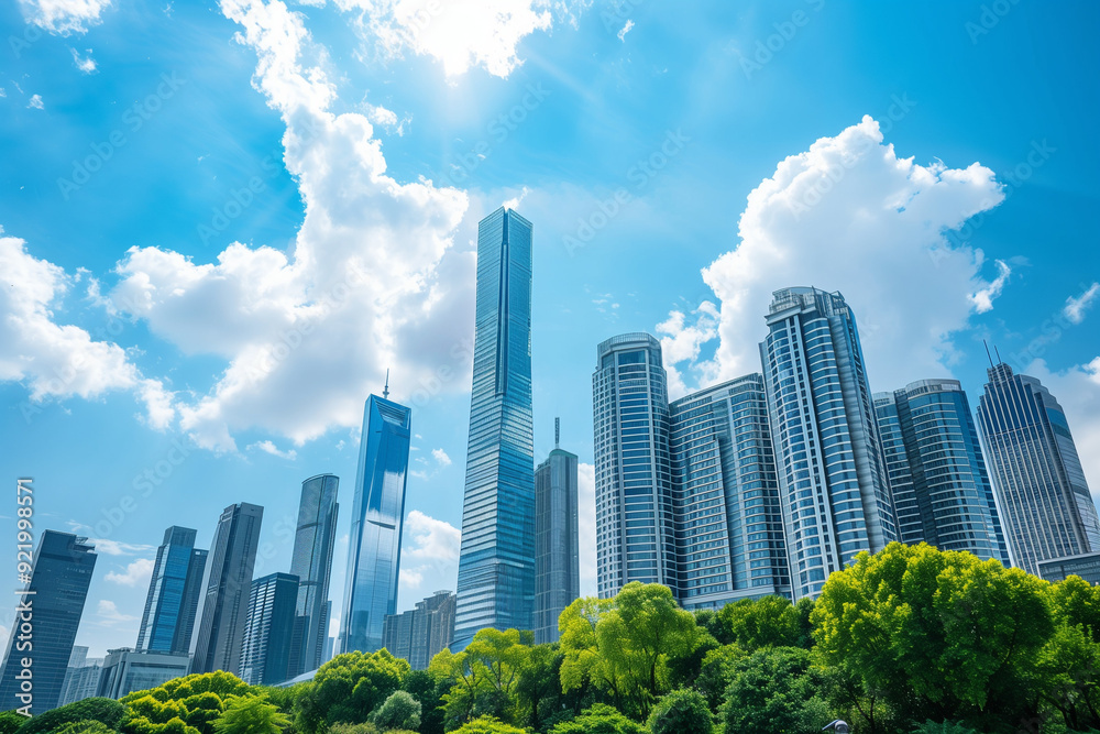 Fototapeta premium Skyscrapers Viewed from Below with Blue Sky and White Clouds