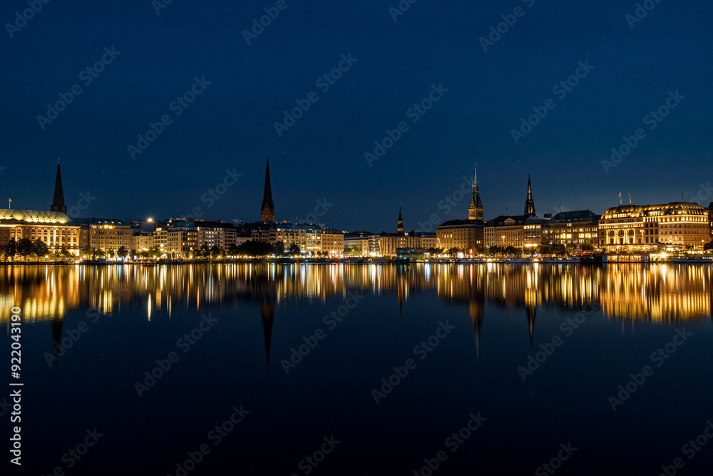 The reflection of the city center onto the water at night in Germany. The northern German city at night in Summer The reflection of the city center onto the water at night in Germany. The northern German city at night in Summer