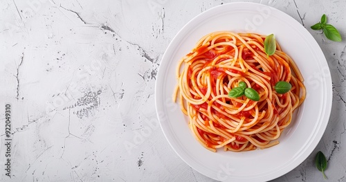Photo of spaghetti with tomato sauce on a white plate, with a top view banner having space for text or a title, laid flat, on a light grey concrete background, with high resoluti